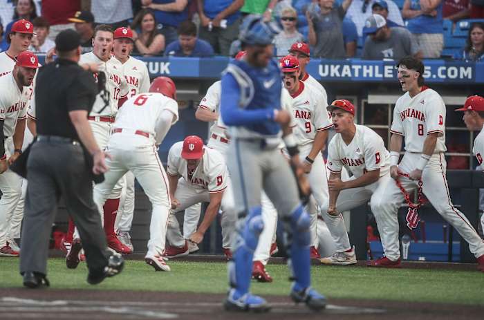 Indiana's Tyler Cerny (8) was ejected from the game after he carried an IU prop -- the IU logo on a chain -- onto the field as the Hoosiers celebrate Peter Serruto's three-run homer in the seventh. The Hoosiers defeated Kentucky 5-3 Saturday night in the 2023 NCAA Regional at Kentucky Proud Park in Lexington.